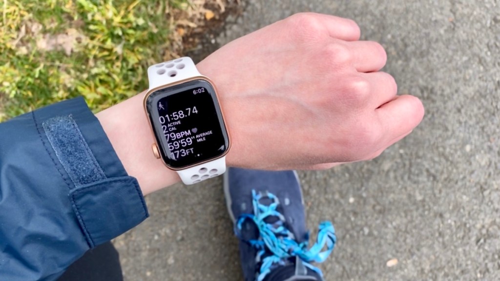My apple watch on my arm, with the walking app open, and my walking shoe in the background. 