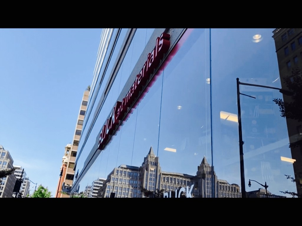 Blick Art Materials in DC storefront with the city reflected in the glass