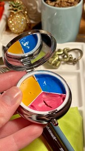 triad of pink yellow and blue paint in a cute little round medicine container