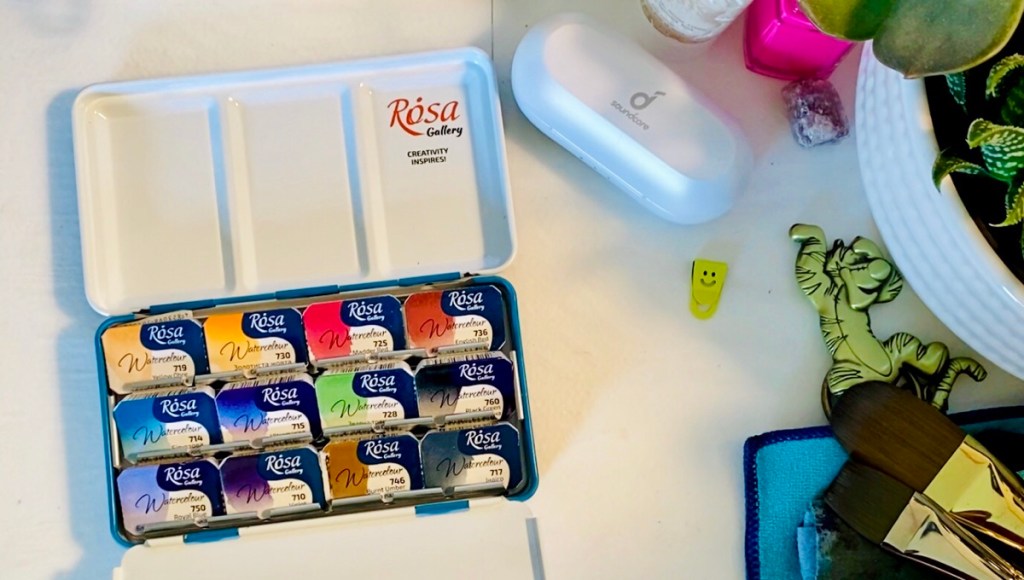 Soundcore Liberty Neo Wireless Earbuds on my desk next to my Rosa watercolor palette 