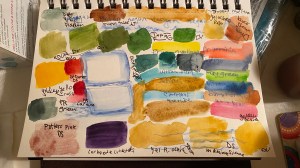 many paint swatches on paper, trying to figure out a color palette